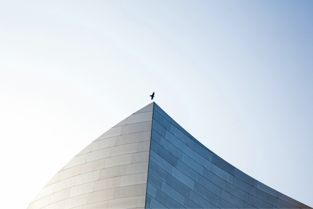 Modern geometric architecture against a pale blue sky